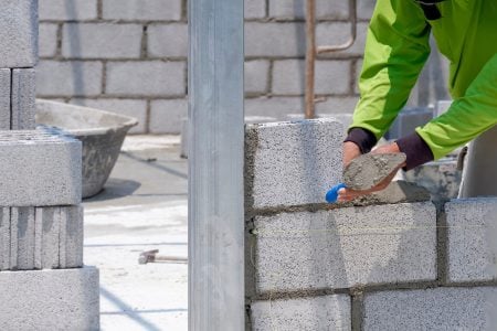bricklayer-hand-using-trowel-to-making-brick-wall-2025-03-11-07-52-59-utc